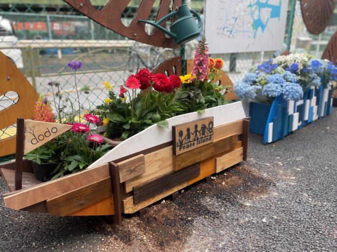 カラフルな花が植えられた木製のプランター